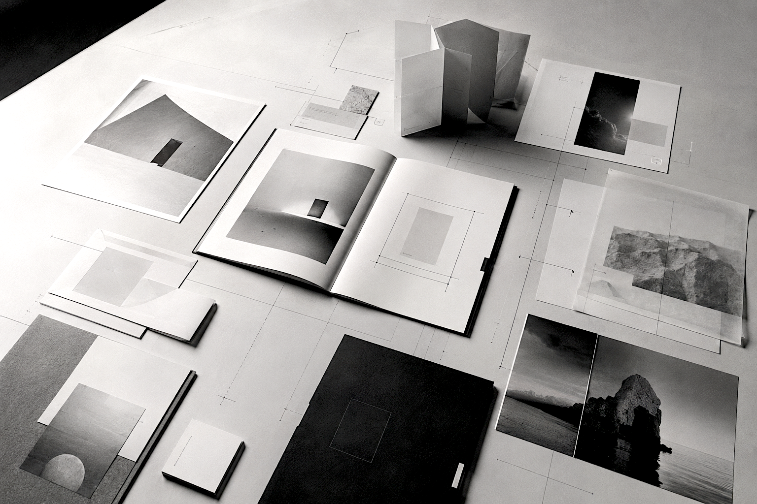 A flat-lay arrangement of editorial print collateral and layout materials